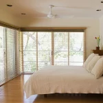 Venetian blinds in bedroom in wood finished