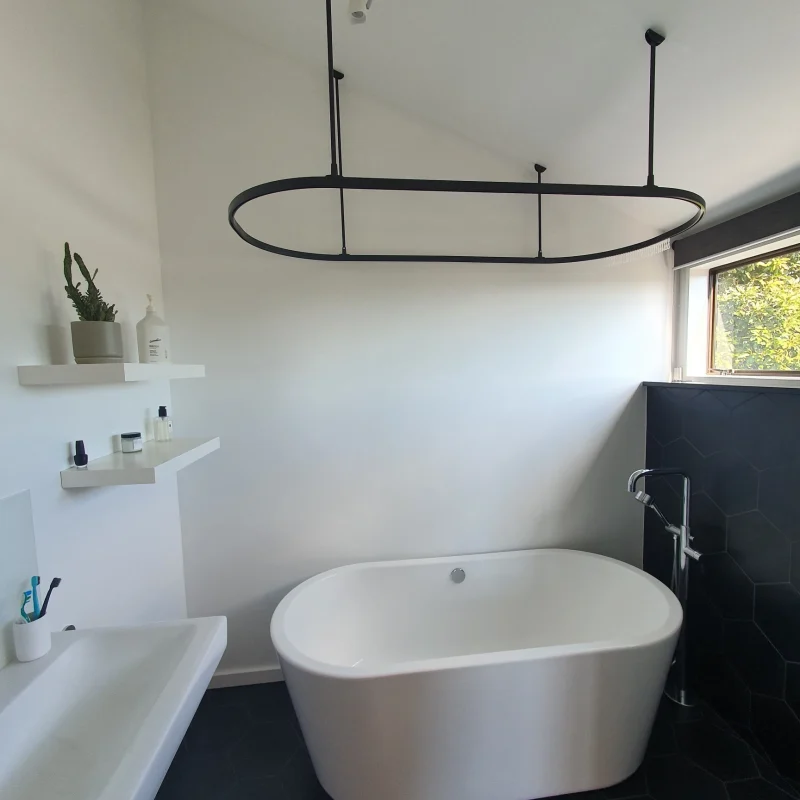 Black oval bath track in renovated bathroom